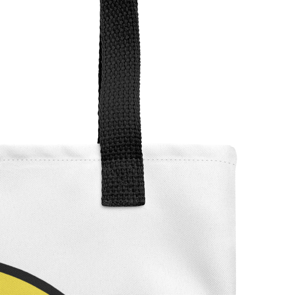Close-up of the Trees, Rivers & UFOs Brain Burger Tote Bag showing the black woven handle, top stitching and textured white fabric.