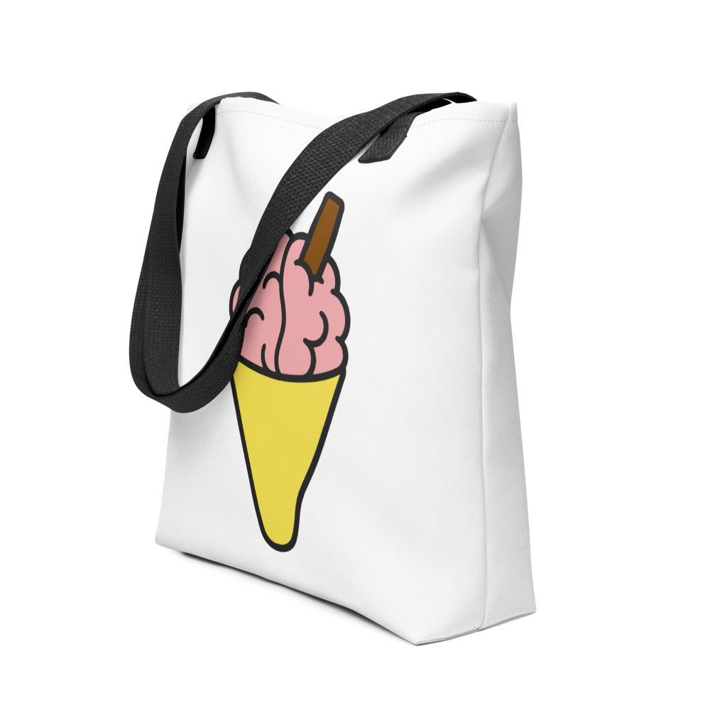 Angled view of the Brain Cream Tote Bag by Trees, Rivers & UFOs showing the pink brain ice cream artwork and black handles.