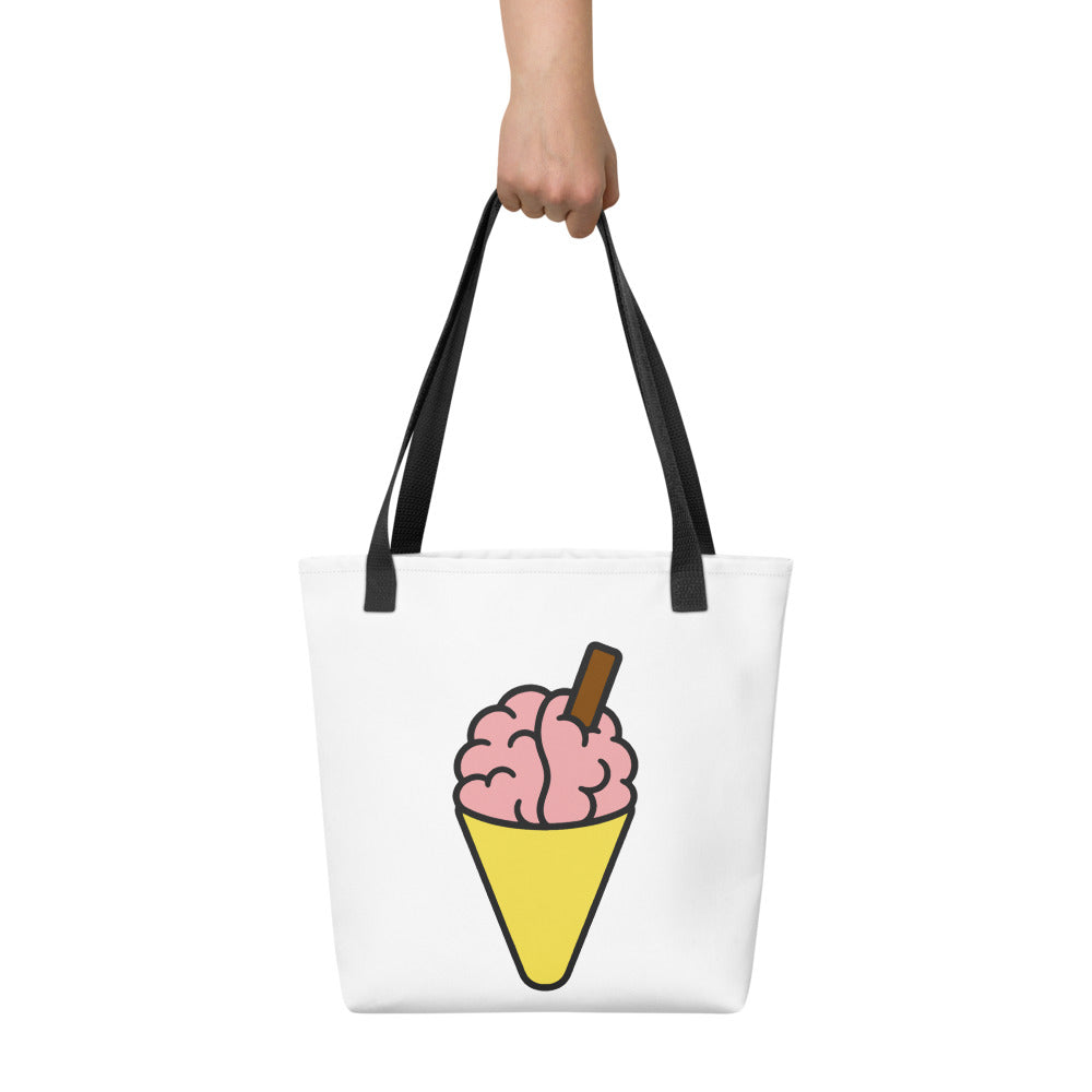 Front view of the Brain Cream Tote Bag by Trees, Rivers & UFOs with pink brain ice cream artwork and black handles.