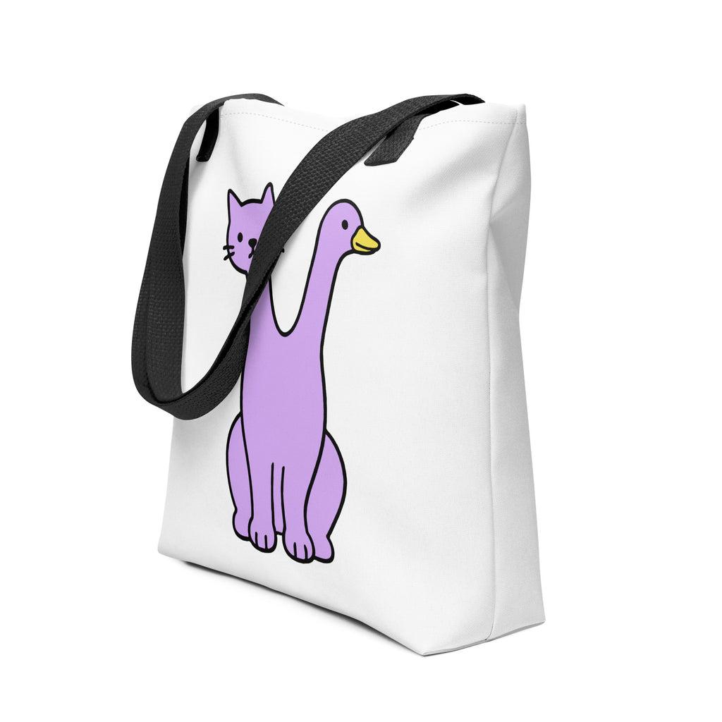 Angled view of the Quackcat Tote Bag by Trees, Rivers & UFOs showing the white bag, black handles and purple two-headed cat and duck artwork.