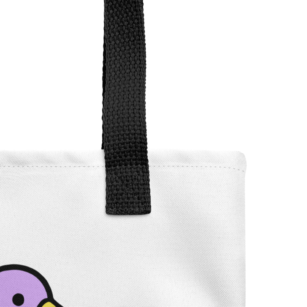 Close-up of the Quackcat Tote Bag by Trees, Rivers & UFOs showing the black woven handle, white fabric and purple artwork detail.